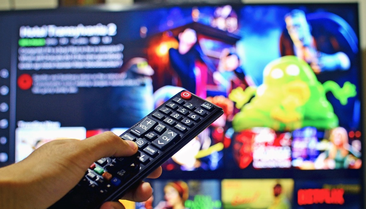 user watching TV, holding a controller